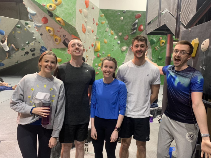 5 smiling Porterhouse employees at climbing wall